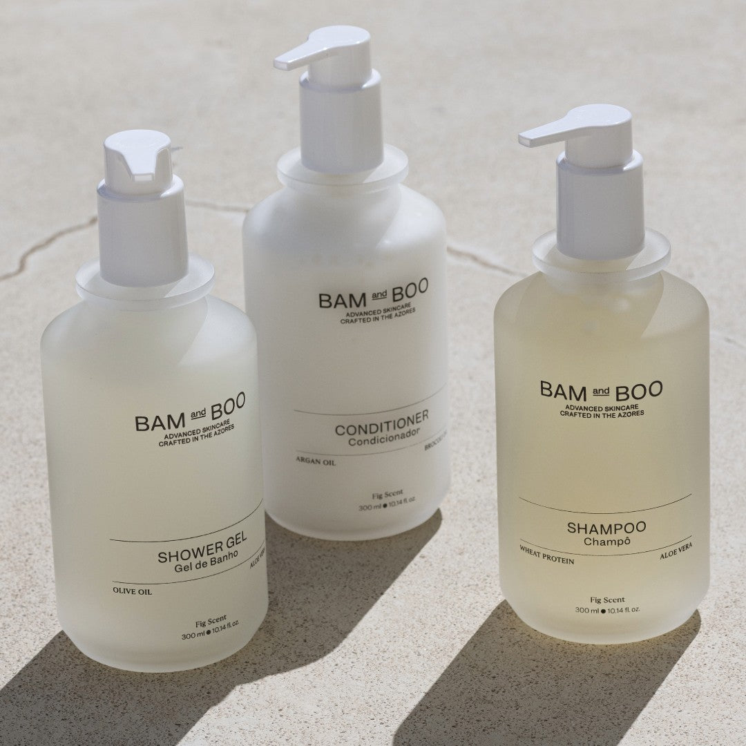 Three bottles of BAM and BOO shampoo, conditioner, and shower gel on a light background. Premium Hotel Amenities made in portugal.